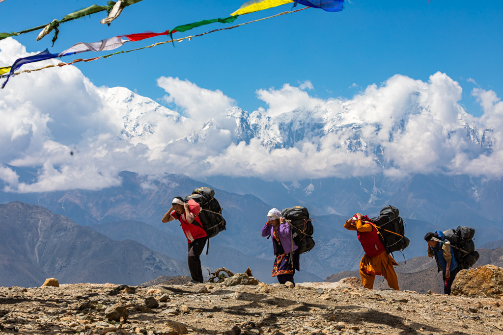 3 people walking on a mountain