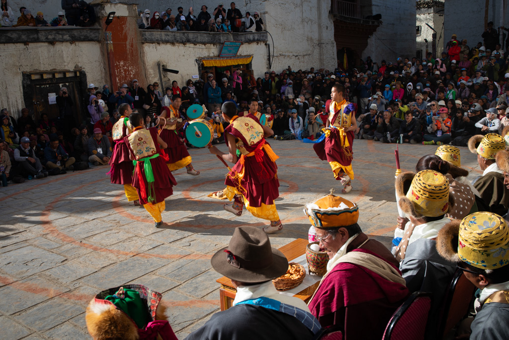 people dancing in a choreography on the street wearing colorful clothes