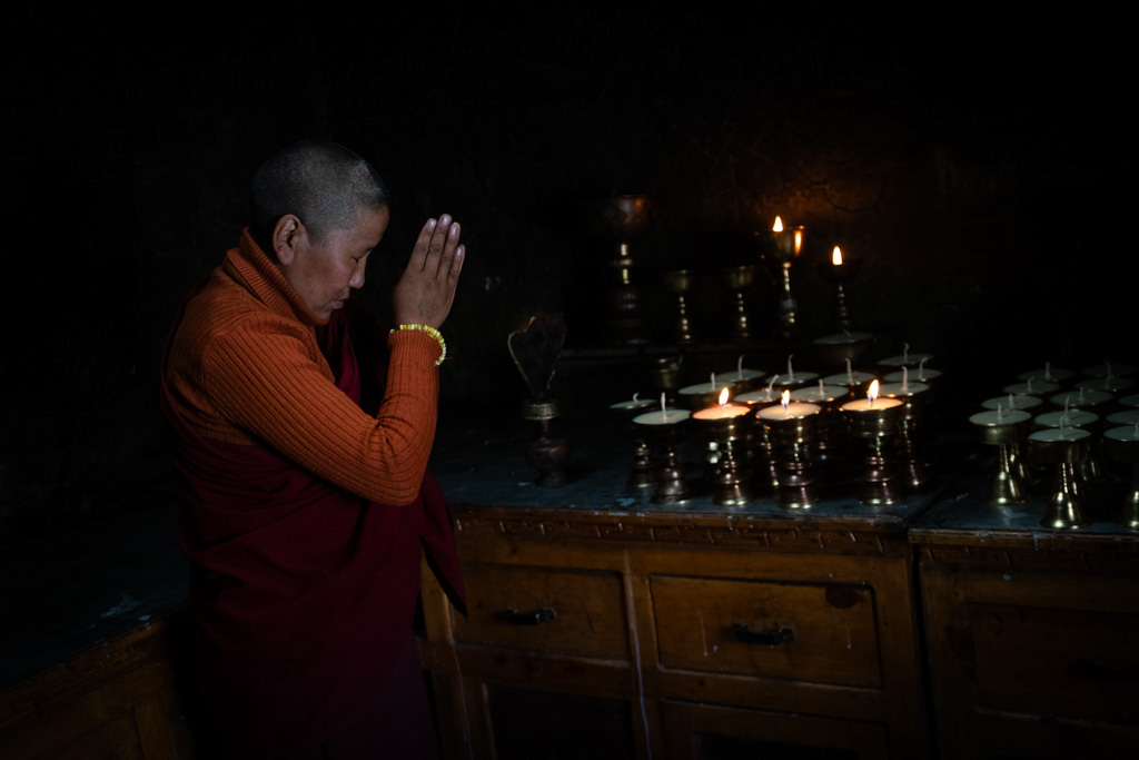 an elderly man kneeling and praying